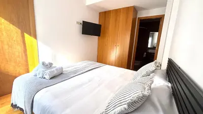 a bedroom with a bed with towels on it at Acogedor apartamento by Prestigi in Terrassa