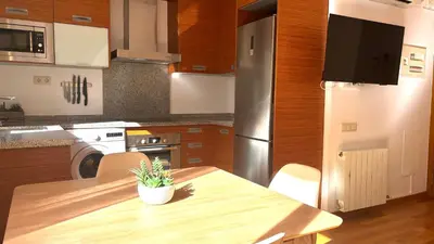 a kitchen with a wooden table with a potted plant on it at Acogedor apartamento by Prestigi in Terrassa