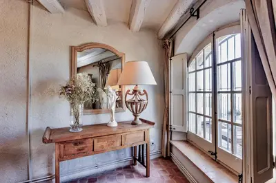 a room with a table with a lamp and a mirror at Montrural in Castellví de la Marca