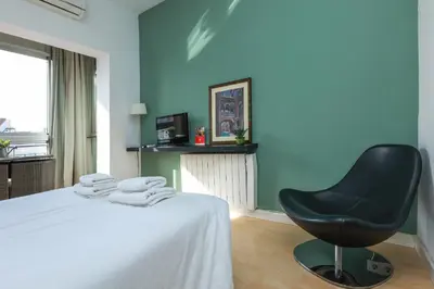 a room with a bed and a black chair at ApartEasy - Lovely Atic in Barcelona in Barcelona