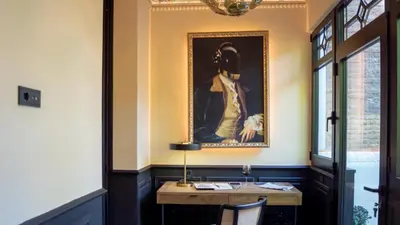 a painting of a man with a dog on a wall at Boada Riera - The RoomsbyReini in Terrassa