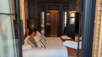 a bedroom with a large white bed with pillows at Boada Riera - The RoomsbyReini in Terrassa