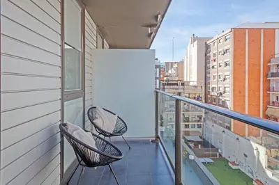 a bedroom with a white bed with a hat on it at BCN MONTJUÏC Apartments in Barcelona