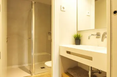 a bathroom with a shower and a sink and a toilet at GuestReady - ARIQUS Apartments in Barcelona