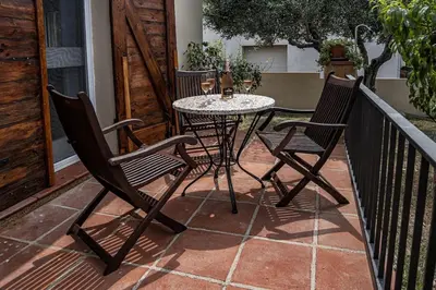 a table and chairs sitting on a patio at Cal Sopas in Collbató