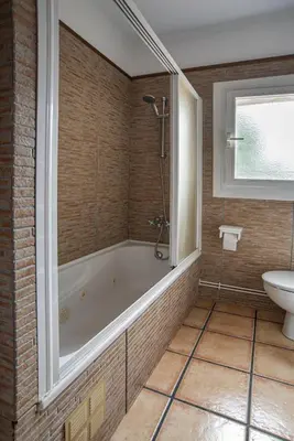a bathroom with a tub and a toilet and a sink at Cal Sopas in Collbató