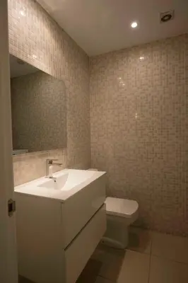 a bathroom with a sink and a toilet and a mirror at Roger De Lluria Design Apartment in Barcelona