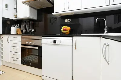 a kitchen with white cabinets and an oven at Magnífico apartamento en el centro in Barcelona