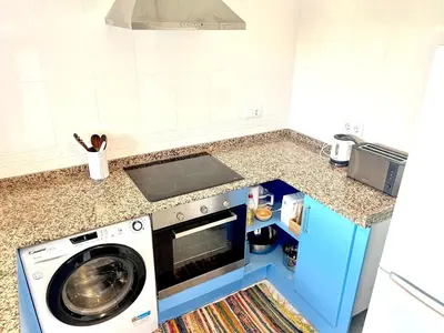 a kitchen with a washing machine in a kitchen at Camins de Montserrat in El Bruc