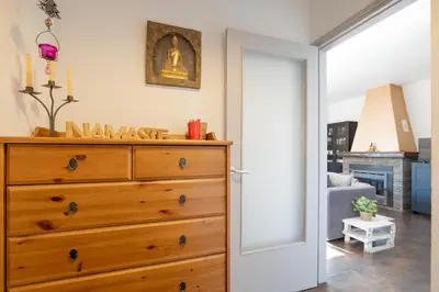 a bedroom with a dresser and a living room at Mima House with Pool in Canyelles