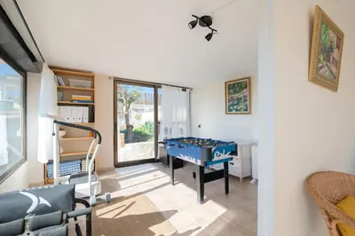 a room with a blue ping pong table in it at Mima House with Pool in Canyelles