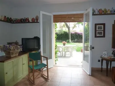 a living room with a door open to a patio at Casa de pueblo con jardín in Premiá de Mar
