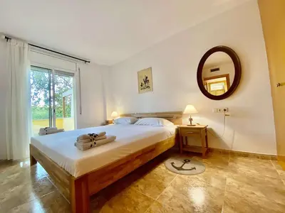 a bedroom with a large bed and a mirror at Amazing apartment close to the beach Eli by Hl in Vilanova i la Geltrú