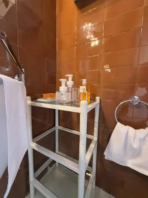 a bathroom with a white table with toiletries on it at Ca La Manso in Sitges