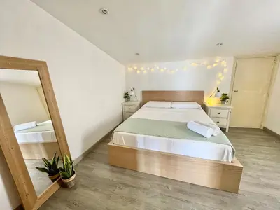 a bedroom with a large bed and a mirror at Mar de Flores in Vilassar de Mar