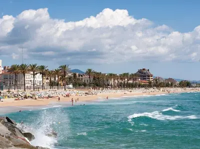 a beach with a lot of people in the water at Mar de Flores in Vilassar de Mar