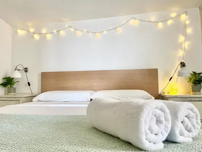 a bedroom with a large bed with towels on it at Mar de Flores in Vilassar de Mar
