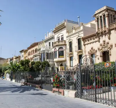 a fence in front of a row of buildings at Mar de Flores in Vilassar de Mar