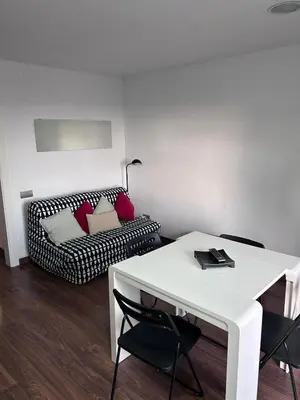 a living room with a white table and a couch at Mery Castelldefels Beach in Castelldefels