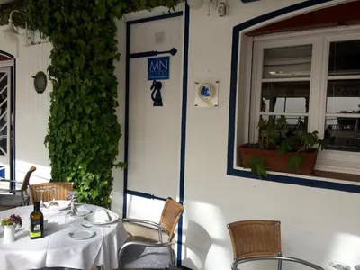 a table with a sign on the door of a restaurant at Apartaments Mare Nostrum in Sitges