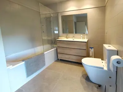 a bathroom with a toilet and a sink and a tub at Exclusive Beach District Flat - Fully Renovated in Barcelona
