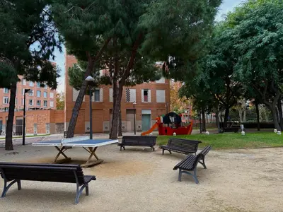 three park benches with a ping pong table in a park at Exclusive Beach District Flat - Fully Renovated in Barcelona