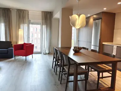 a kitchen and dining room with a wooden table and chairs at Exclusive Beach District Flat - Fully Renovated in Barcelona