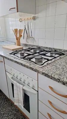 a white stove top oven sitting in a kitchen at Cozy apartment next to the beach in Sitges