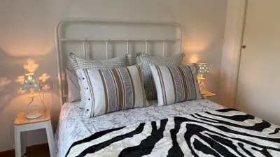 a bedroom with a bed with a zebra print pillow at Apartamento precioso en primera línea de mar in Les Botigues de Sitges
