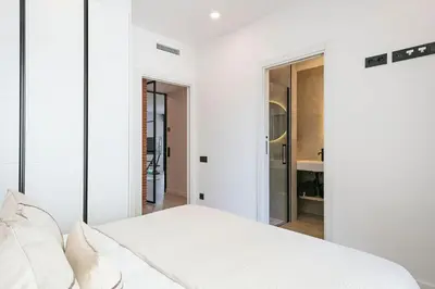 a bedroom with white walls and a white bed at 3 Bedroom Cozy Apartment In Joan Austria in Barcelona
