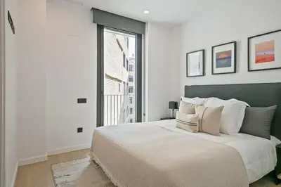 a bedroom with a large bed and a large window at 3 Bedroom Cozy Apartment In Joan Austria in Barcelona