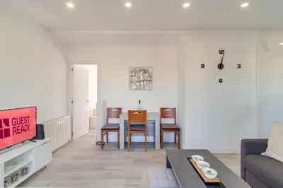 a living room with a couch and a table and chairs at Guest Ready‑Bright & Stylish Flat with 3 Terraces in Barcelona