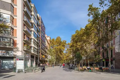 a street in a city with tall buildings at Guest Ready‑Bright & Stylish Flat with 3 Terraces in Barcelona