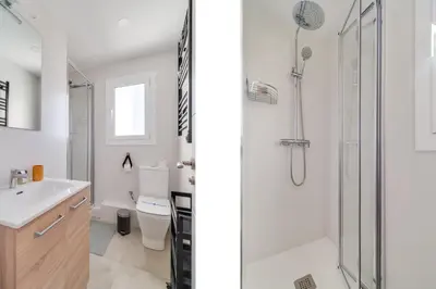 a white bathroom with a shower and a sink at Guest Ready‑Bright & Stylish Flat with 3 Terraces in Barcelona