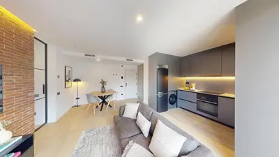 a living room with a couch and a table at 1 Bedroom Cozy Aparment Joan Austria in Barcelona