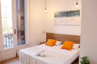 three beds in a room with a window at lullaby by hamilton in Barcelona