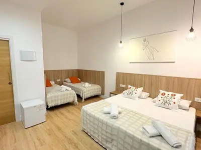 a small bedroom with a bed and a desk at lullaby by hamilton in Barcelona