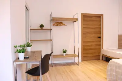 a bedroom with a bed and a sliding glass door at lullaby by hamilton in Barcelona
