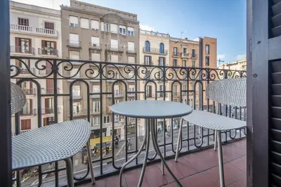 a dining room with a glass table and chairs at Uptown Barcelona You Stylish Apartments in Barcelona