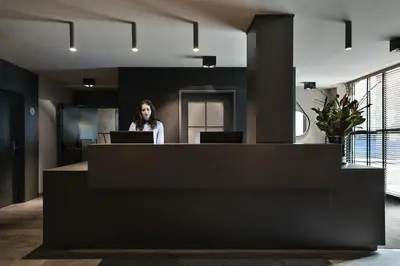 a woman standing behind a counter in an office at Upper Diagonal in Barcelona