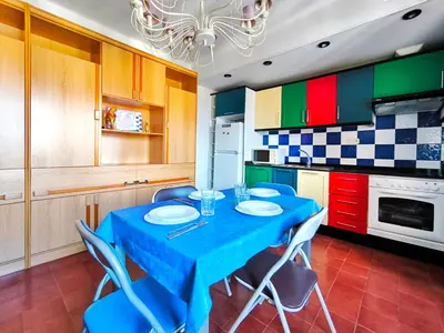 a kitchen with a blue table and chairs in it at Apartamento Canet de Mar Playa, Costa de Barcelona in Canet de Mar