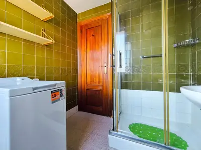 a bathroom with a shower and a sink and a toilet at Apartamento Canet de Mar Playa, Costa de Barcelona in Canet de Mar