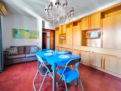 a dining room with a blue table and blue chairs at Apartamento Canet de Mar Playa, Costa de Barcelona in Canet de Mar