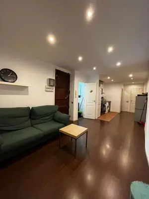 a living room with a green couch and a table at Private Room Barcelona center in Barcelona