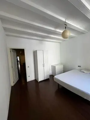 a white bedroom with a bed and a room with a hallway at Private Room Barcelona center in Barcelona