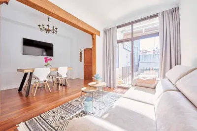 a living room with a white couch and a table at Apartamento en Caldes d'Estrac in Caldes d'Estrac