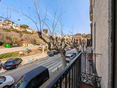 a balcony with cars parked on a city street at Apartamento en Caldes d'Estrac in Caldes d'Estrac