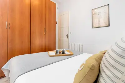a bedroom with a bed with a tray of chess at Whisper-Quiet 2BR Near Sagrada in Barcelona