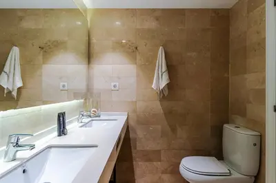 a bathroom with a sink and a toilet and a mirror at Enjoybcn Plaza Catalunya Apt. in Barcelona