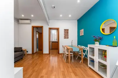 a bedroom with a bed and a desk and a window at Mediterranean and connected in Sant Adria de Besos